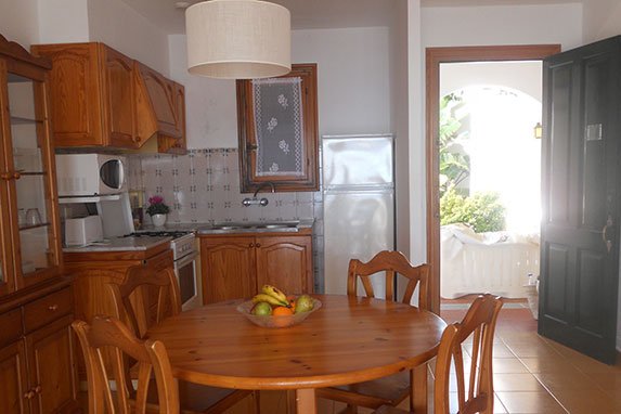 Salón, cocina y puerta de entrada al apartamento Rocas Marinas 2R.